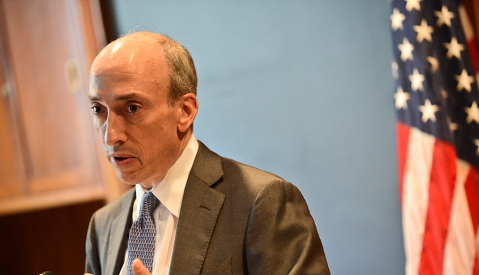 Gary Gensler, presidente da SEC, ao lado da bandeira dos Estados Unidos