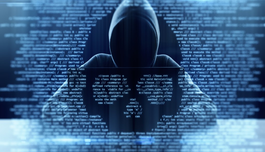 Ilustração de hacker encapuzado atrás de vidro com imagem de caveira