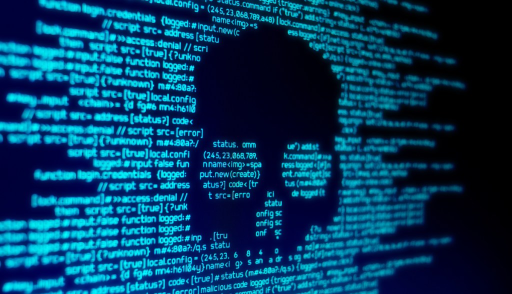 codigo de computador em uma tela com um crânio representando um ataque hacker