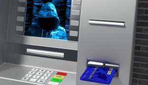 Tela de caixa eletrônico mostra um hacker encapuzado