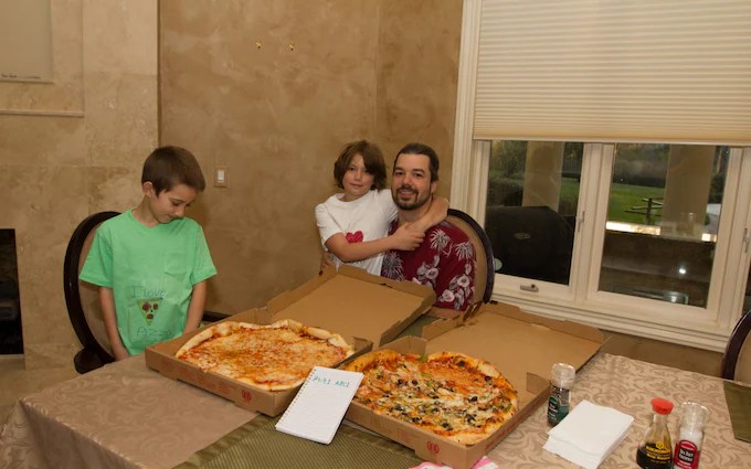 Laszlo Hanyecz e seus filhos em 2010 com as pizzas que custaram 10.000 BTC