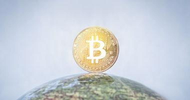 moeda de Bitcoin em cima de globo terrestre e mundo