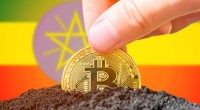 Moeda de Bitcoin semienterrada à frente de bandeira da Etiópia